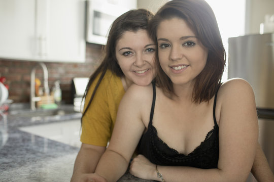 Lesbian couple sitting in kitchen together