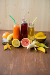 Delicious array of fresh fruit juices served in tall glasses made from liquidised orange, kiwifruit with peppermint, and strawberries for healthy summer treats rich in vitamins