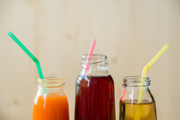 Delicious array of fresh fruit juices served in tall glasses made from liquidised orange, kiwifruit with peppermint, and strawberries for healthy summer treats rich in vitamins