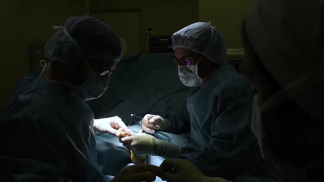 Surgeons doing a foot surgery. 