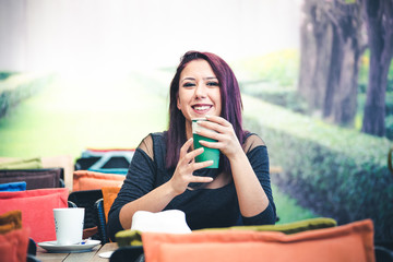 Beautiful girl drinking coffee at the coffee shop