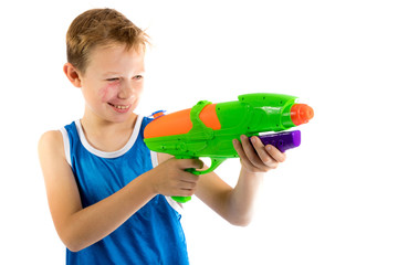 Pre-teen boy playing with water guns