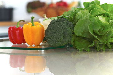 Kitchen interiors. Many vegetables and other meal at glass table are ready for been cooked soon