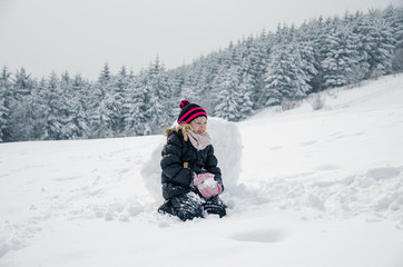 Fototapeta na wymiar little child in snowy winter time