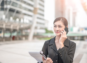 Young Asian business woman use cellphone, closeup portrait.