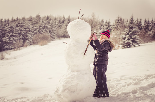 Little Child Building A Big Snowman