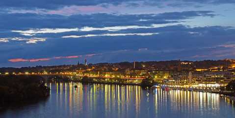Night scene of Georgetown waterfront in Washington DC, USA. Illuminated Key Bridge and Potomac River after sunset.