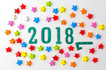 2018 New year concept. Group of businessman and business woman miniature figures sitting on 2 0 1 8 number wooden block toy on world map.