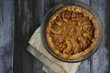 Homemade apple quince pie on rustic wooden background. Top view