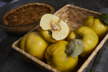 Homemade apple quince pie with fresh fruits on rustic wooden background. Top view