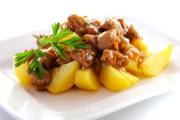 Goulash, beef stew with potatoes, isolated on white background.