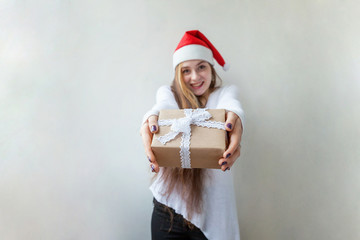 Girl in Santa hat with chrismass gift