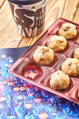 Delicious homemade sweets, a magazine with a vivid picture, a plastic glass with a cafe, tea, cocoa. Drink on take-away and a set of sweets. Ideal evening, morning, day off, weekend.