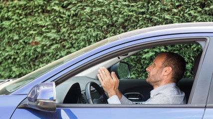 Stressed and annoyed male driver on the road during the rush hour