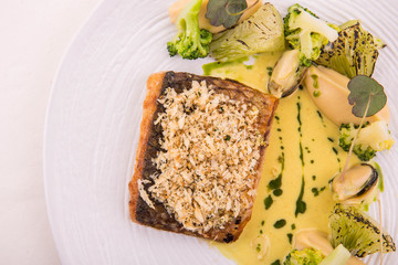 The mullet Black Sea with new potato and cabbage, is served in sour cream sauce with leek