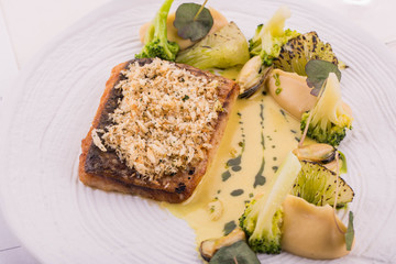 Fish with cabbage and new boiled potato, is served with leek in sour cream sauce with fennel