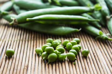 ripe green peas on wooden background
