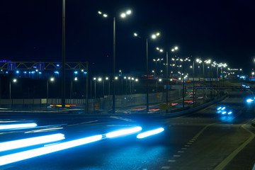 Fototapeta na wymiar Highway traffic cars at night blured. Cars moving on road on bridge evening blurry.