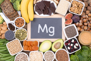 Magnesium food sources, top view on wooden background - obrazy, fototapety, plakaty