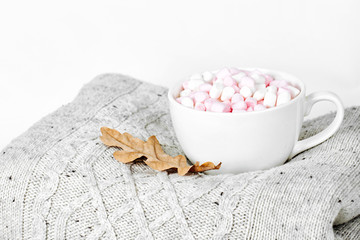 Warm sweaters with cup of coffee.