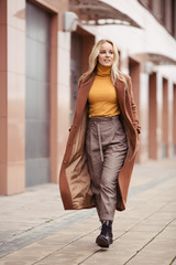 Blonde woman wearing in stylish coat in city