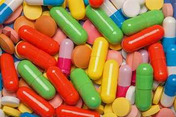 colored pills a lot of red yellow green