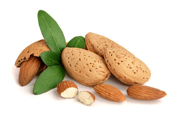 Group of almond nuts with leaves isolated on white background