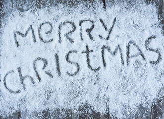 Merry christmas hand drawn lettering on wooden board