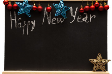 Fototapeta na wymiar Inscription Happy New Year written by white chalk on decorated with Christmas decorations school blackboard with copy space. Christmas concept background.