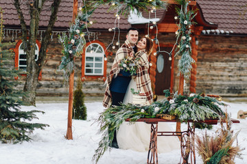 Winter wedding, beautiful bride and groom hide plaid