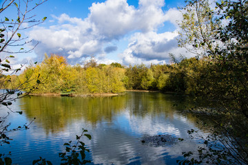 Fototapeta na wymiar Autumn colour reflections in a calm still lake
