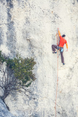 A man climbs the rock.