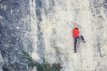 A man climbs the rock.