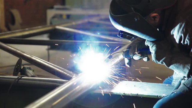 welder working and soldering iron with mask-slider shot