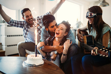 Cheerful young friends having fun on party