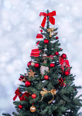 Beautiful decorated christmas tree with present boxes in a winter landscape with snow