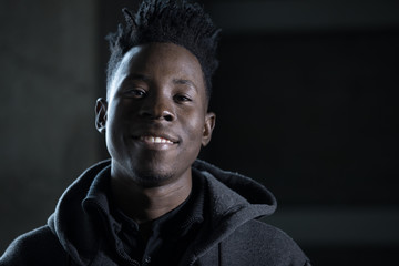 Rapper african man smiling portrait in darkness