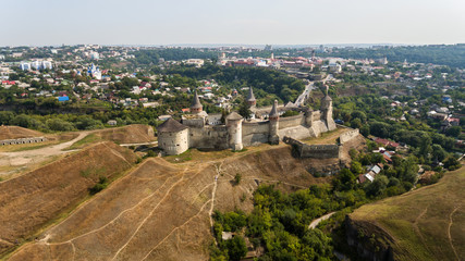 Aerial view of Kamianets-Podilskyi castle in Ukraine. The fortress located among the picturesque nature in the historic city of Kamianets-Podilskyi, Ukraine.