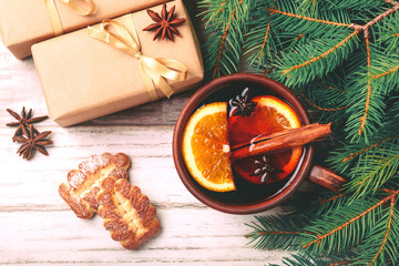 Hot mulled wine with spices and cookies. Christmas tree
