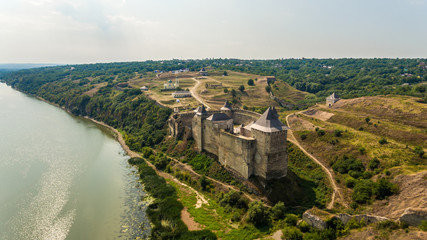 Aerial view of Khotyn medieval castle on the green hill above the river.