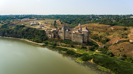 Obraz premium Aerial view of Khotyn medieval castle on the green hill above the river.
