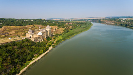 Aerial view of Khotyn medieval castle on the green hill above the river.