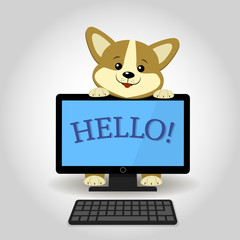 A cute Corgi dog is behind Black computer with the word hello.