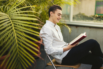 Man sit on the library and read book with blur background