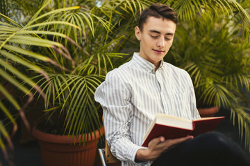 Man sit on the library and read book with blur background