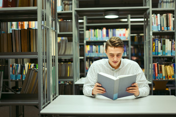 Man sit on the library and read book with blur background