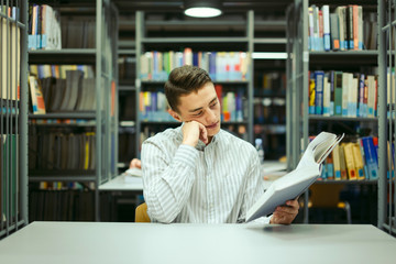 Man sit on the library and read book with blur background