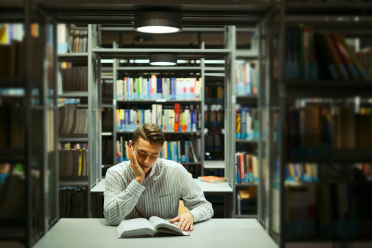 Man sit on the library and read book with blur background