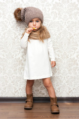 Cute young girl in winter hat and scarf