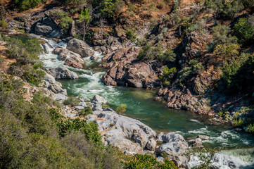 Naklejka na ściany i meble Picturesque mountain river in the Kings Canyon Preserve, California. Clear water of a mountain river